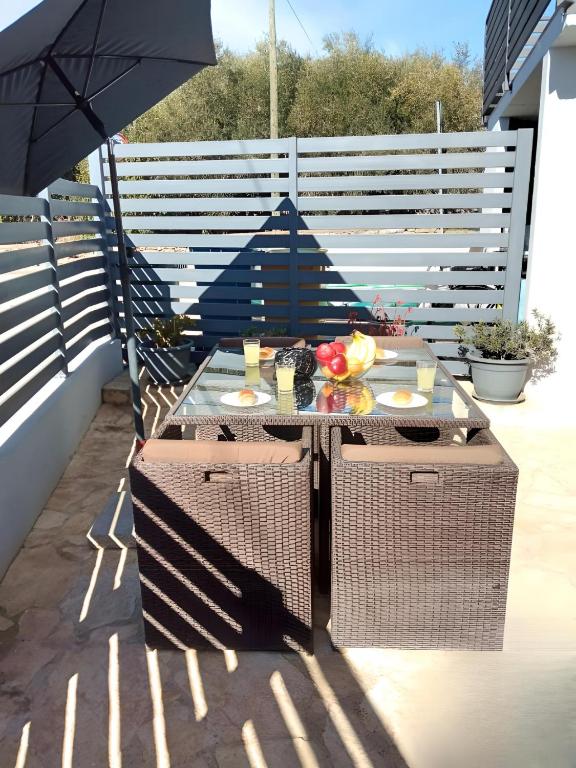 a table on a patio with an umbrella at Apartment Patrik in Vabriga