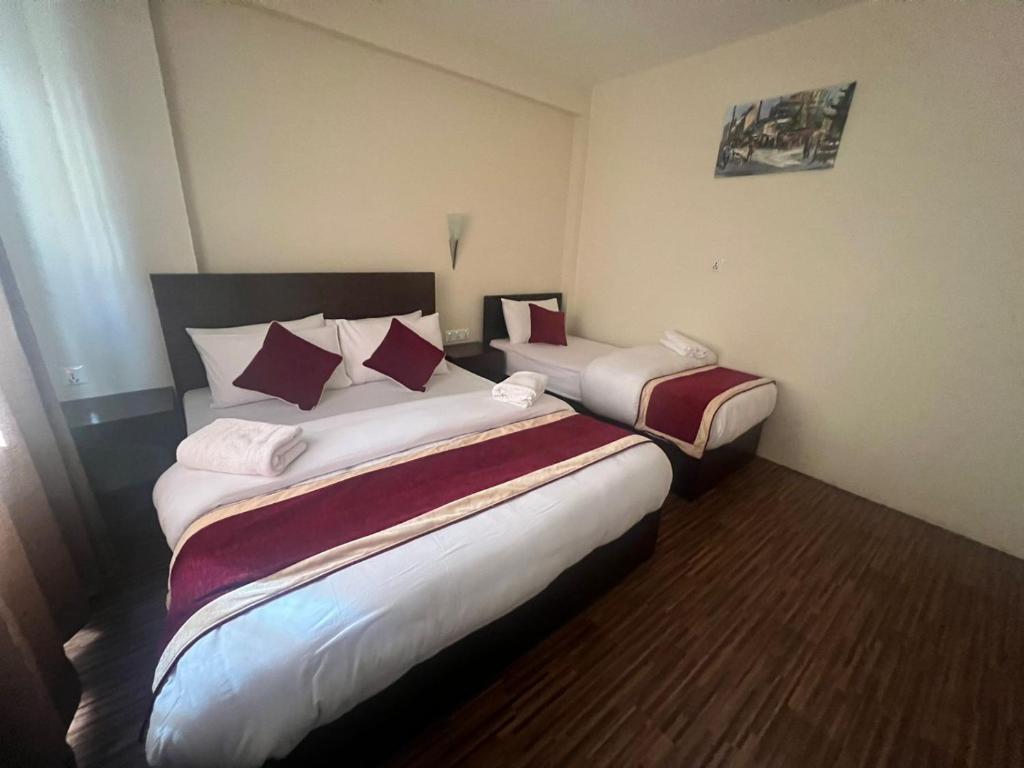 a hotel room with two beds in it at Hotel Down To Earth in Kathmandu