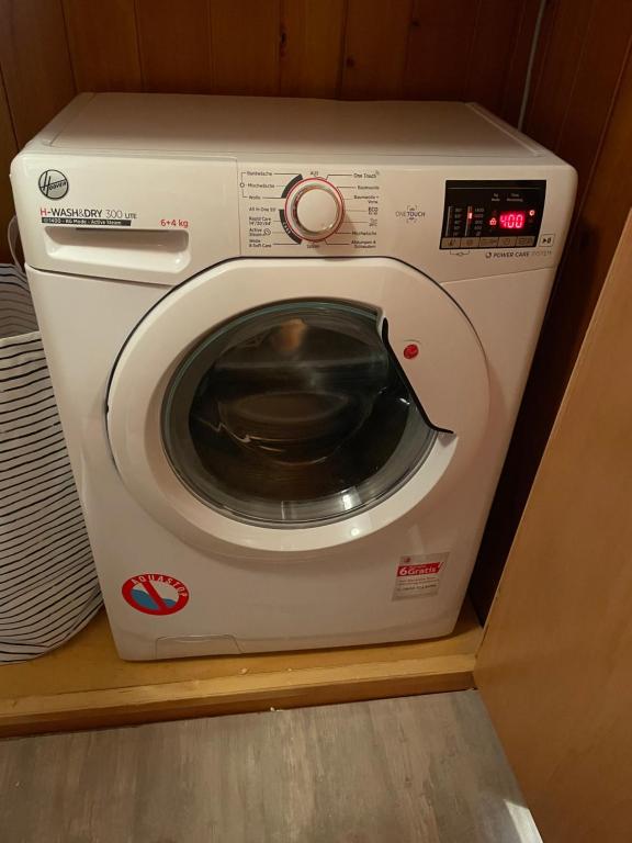a white washing machine sitting on a shelf at Appartamento Kern-Sciare A Portata Di Mano- in Madesimo