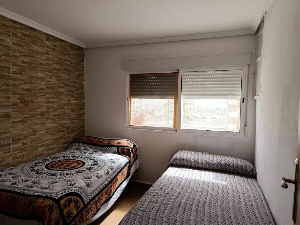 a bedroom with a bed and a window at El Mirador"Venerable Escuder" in Cocentaina