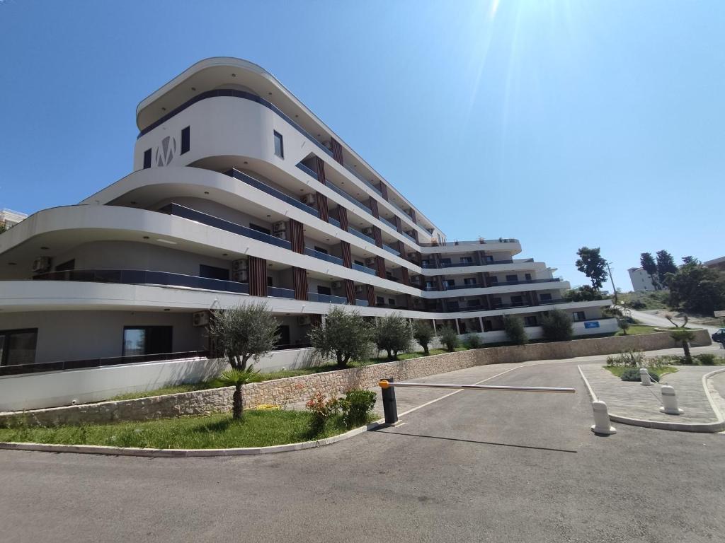 a parking lot in front of a building at Allure Apartments in Ulcinj