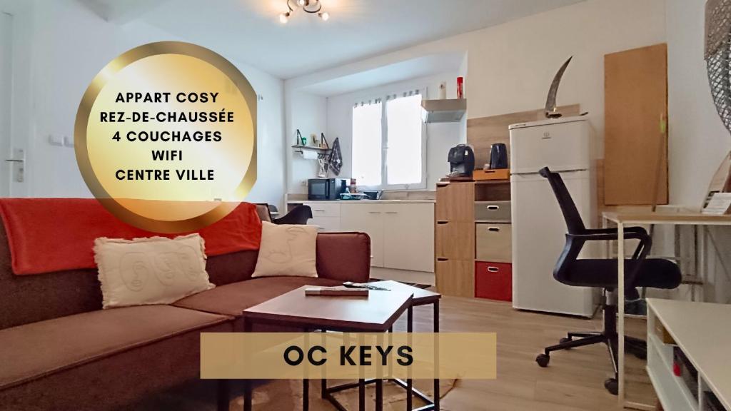 a living room with a couch and a table at Appartement Cosy T3 Oc Keys in Limoux