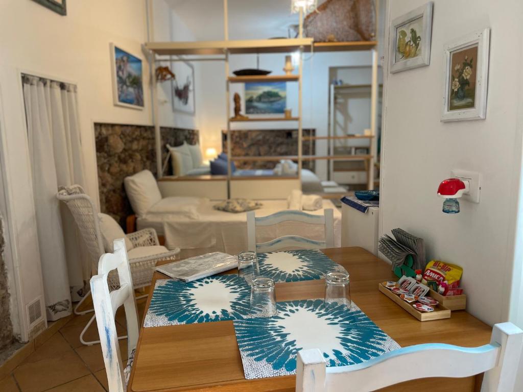 a dining room with a table and a living room at Salu’ in Taormina