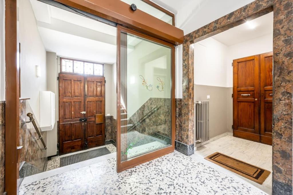 a bathroom with a shower and a glass door at Cucchiari Suite 8B in Modena