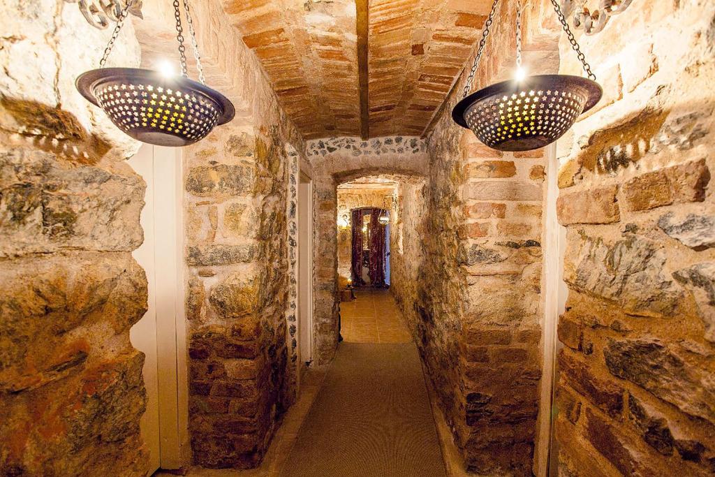 a hallway with two lights on a stone wall at Kaboom Showroom & Guesthouse in Istanbul