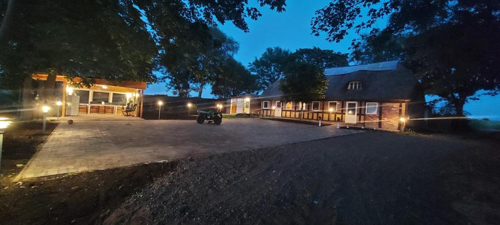 a house with lights in front of it at night at Charming Countryside Oasis Near Horsens, 2 in Hornsyld