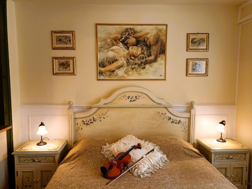 a bedroom with a bed with a violin on it at Something About Mary in Athens