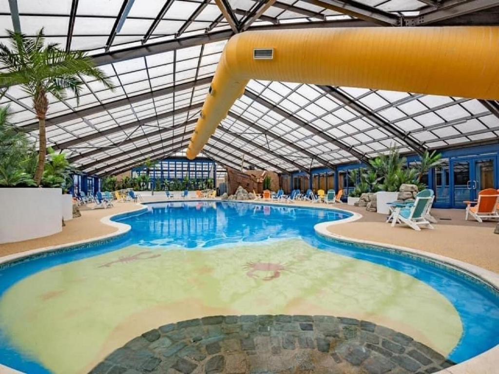 a large swimming pool with a slide in a building at Caravan Delta 2 Bedroom in Rhyl in Rhyl