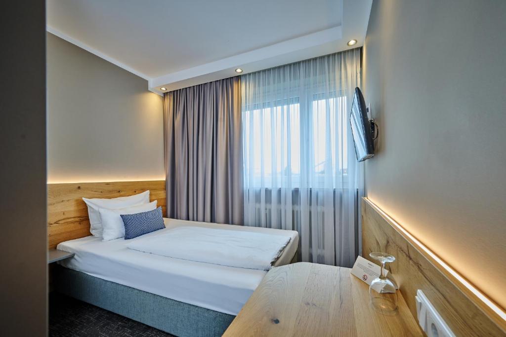 Postel nebo postele na pokoji v ubytování Hotel Westend