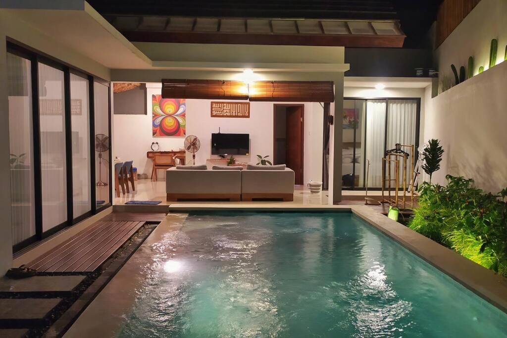 a swimming pool in the middle of a house at Nako Tropical House 2BR at Bali Bukit Uluwatu - Ungasan in Uluwatu