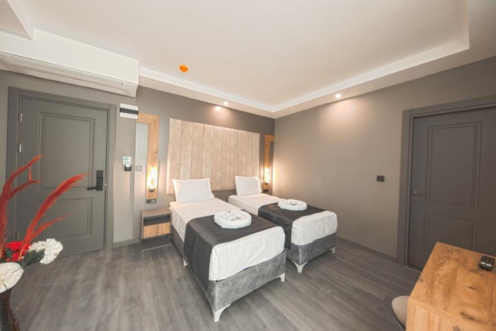 Postel nebo postele na pokoji v ubytování İstanbul City Airport Hotel
