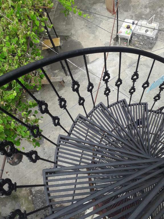 a metal bench sitting on top of a balcony at DATI in Borjomi