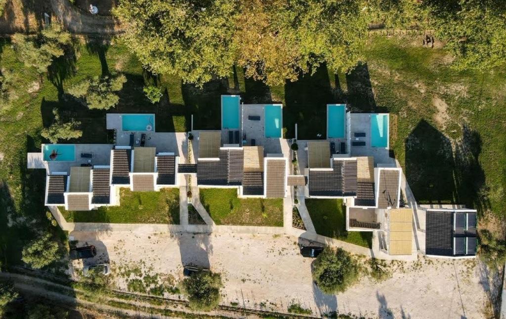 an aerial view of a building with blue roofs at Astrum Luxury Suites in Vourvourou