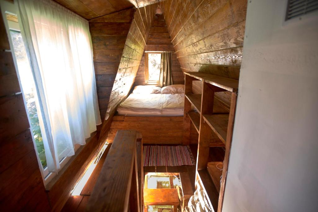 Habitación pequeña con cama en una casa de madera en Baba Yagas house, en Rakhiv