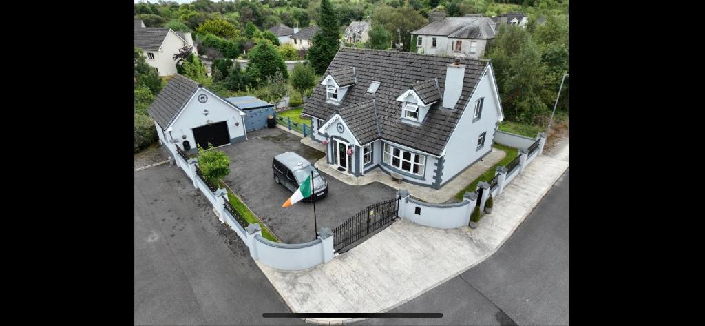 an overhead view of a large white house with a yard at Kev's Place in Keshcarrigan
