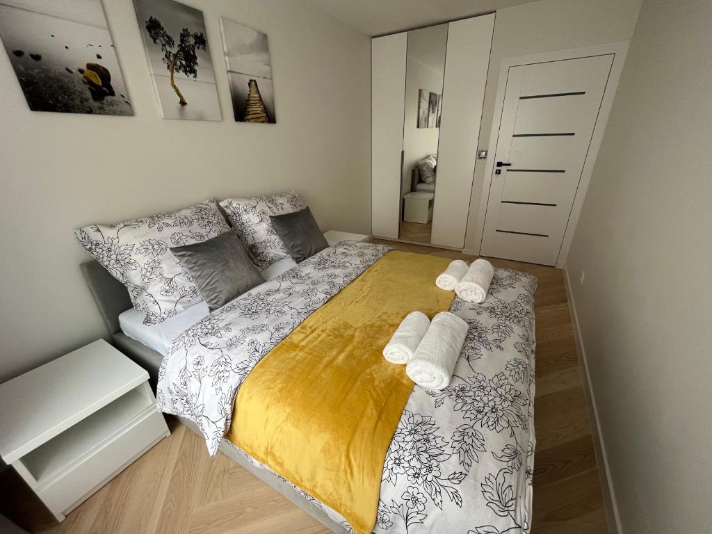 a bedroom with a large bed with two towels at Widok Kielce - Apartament przy Rynku in Kielce
