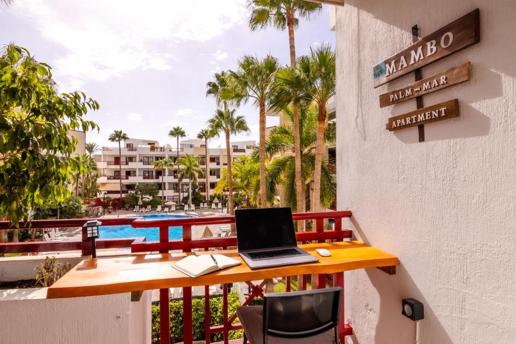 a laptop computer sitting on a table on a balcony at Mambo Palm-Mar apartment in Palm-mar