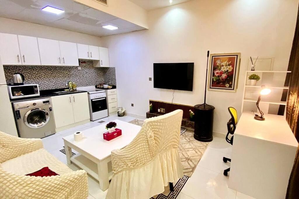 a kitchen with a table and chairs in a room at Romantic Hideaway, 1-BHK Villa in Dubai