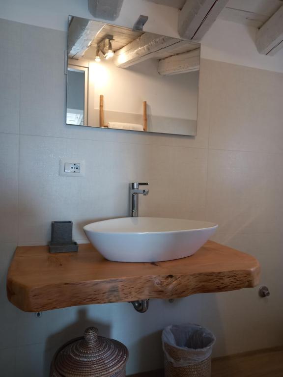 a bathroom with a white sink and a mirror at Aloha Marzamemi Rooms in Marzamemi