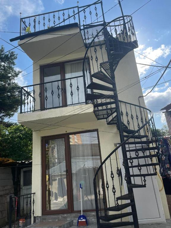 a building with a spiral staircase on the side of it at DATI in Borjomi