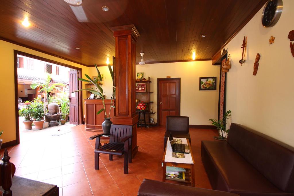 a living room with a couch and a table at Luang Prabang Champa Villa in Luang Prabang