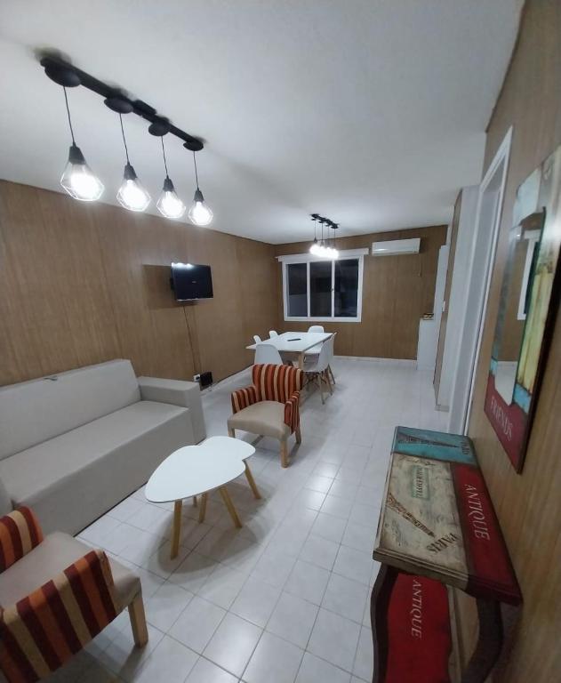 a living room with a couch and a table at Tu Casita de Paso in General Acha