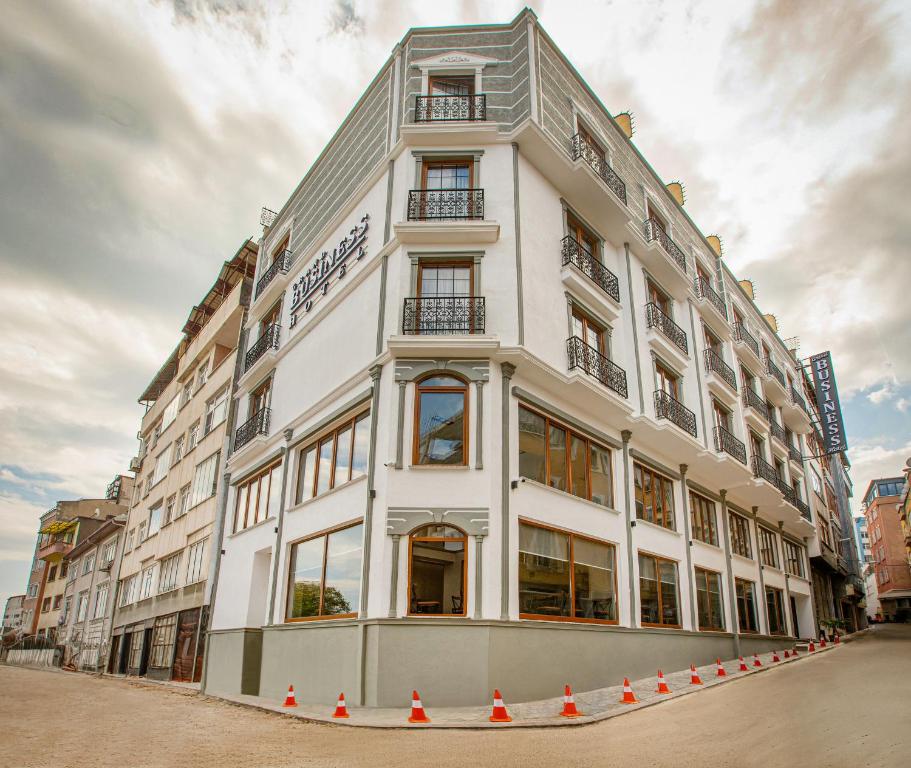 a large white building with orange cones around it at Grand Business Hotel in Trabzon