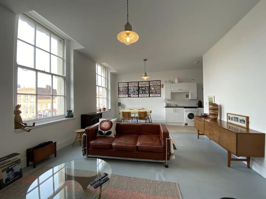 a living room with a brown couch and a table at 2-bed in central Margate in Kent