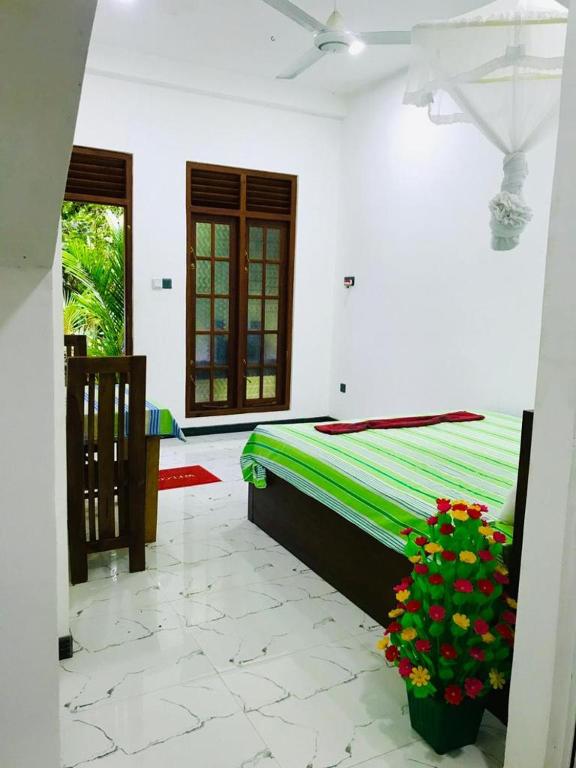 Postel nebo postele na pokoji v ubytování Green jade Inn Mirissa