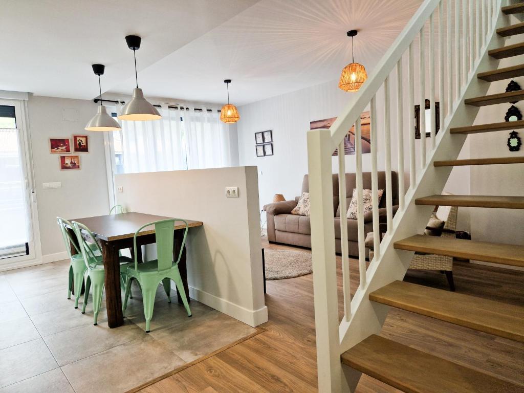 a dining room and living room with a table and chairs at Algorri - ONGI ETORRI in Zumaia