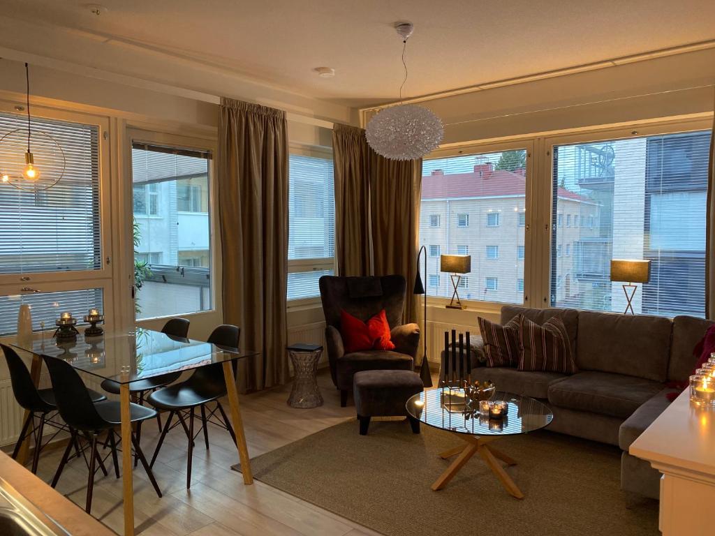 a living room with a couch and a table at Apartment Leppä Rovaniemi in Rovaniemi