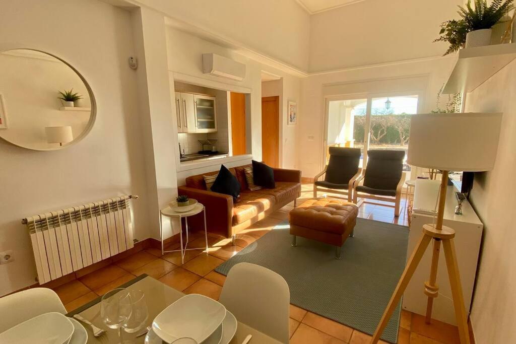 a living room with a couch and chairs and a mirror at Villa Alegre - 2 bed villa with private heated pool on Mar Menor Golf - family friendly in Torre-Pacheco