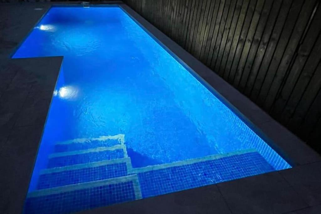 a swimming pool with blue water in a building at Villa Alegre - 2 bed villa with private heated pool on Mar Menor Golf - family friendly in Torre-Pacheco