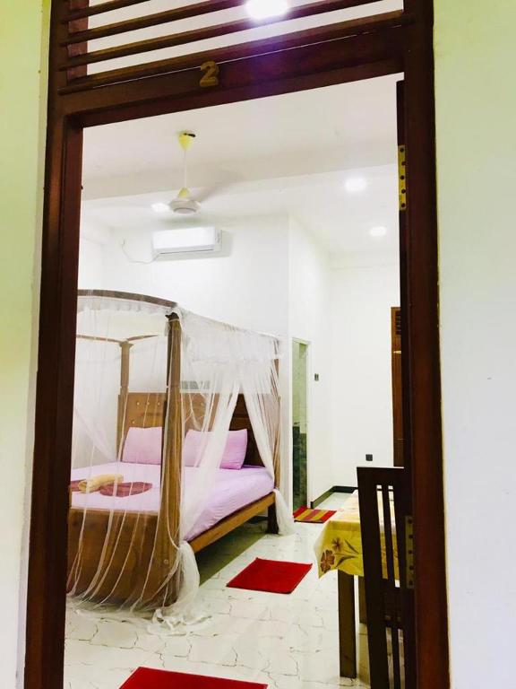 Postel nebo postele na pokoji v ubytování Green jade Inn Mirissa