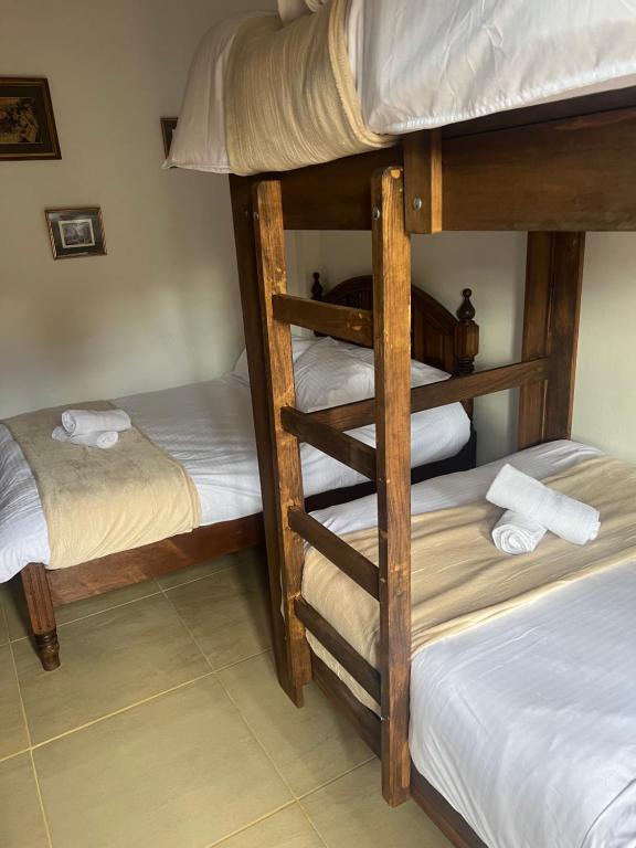 Postel nebo postele na pokoji v ubytování Villa Minta Cabañas