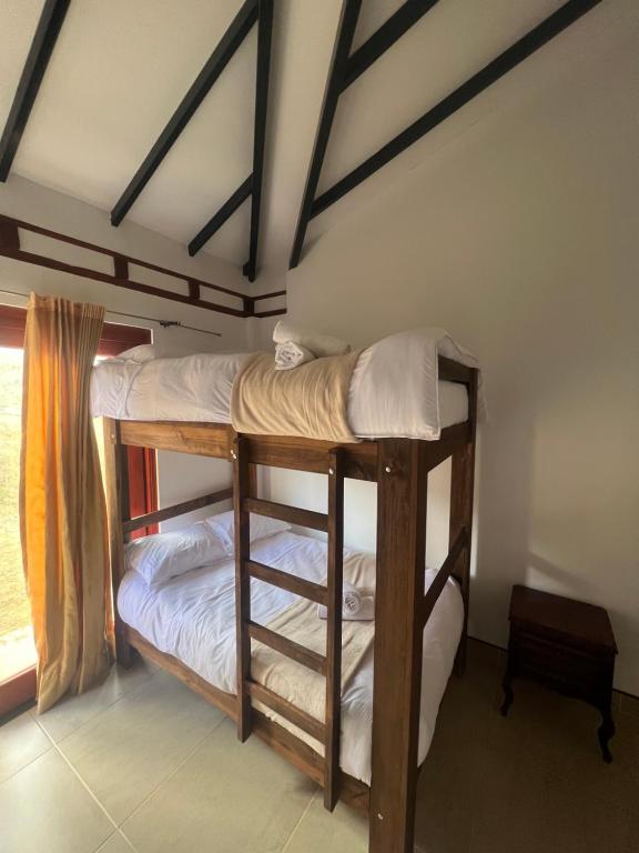 Postel nebo postele na pokoji v ubytování Villa Minta Cabañas