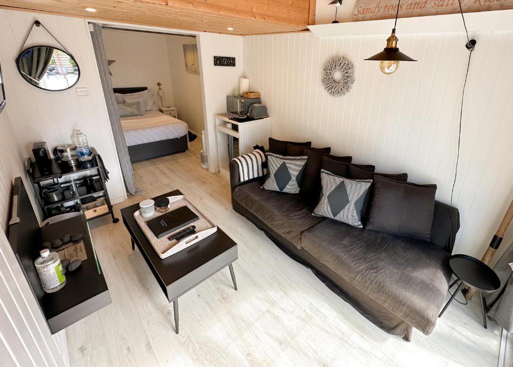 a living room with a couch and a table at Beautiful 1-Bed Cabin in Hayling Island in South Hayling