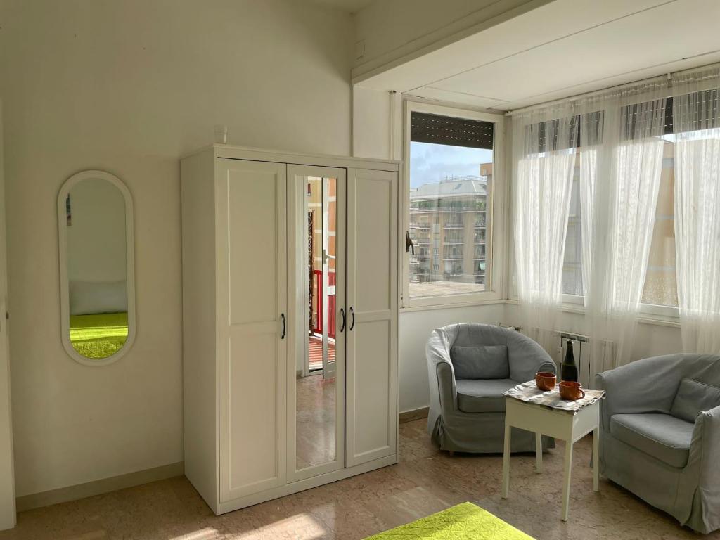 a living room with two chairs and a table at Group Apartment Roma in Rome