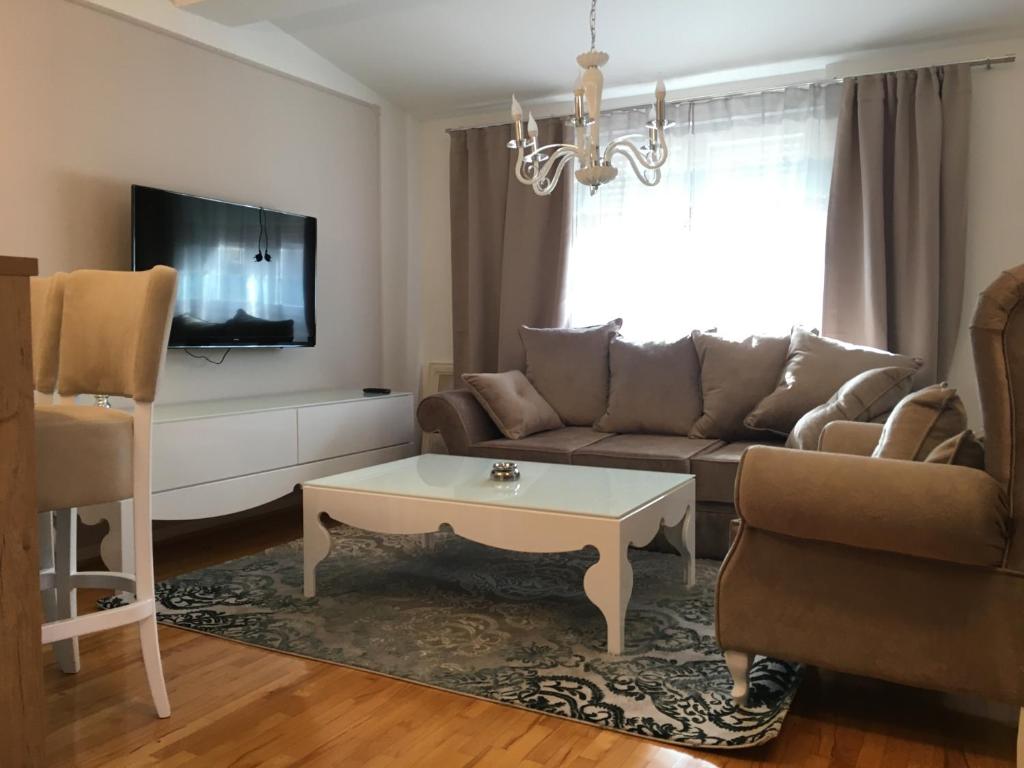 a living room with a couch and a coffee table at cream apartment in Banja Luka