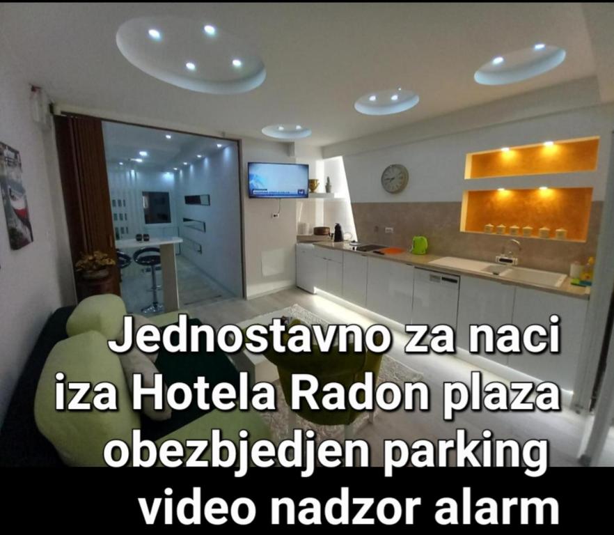 a living room with a kitchen and a room with at Apartman 101 in Sarajevo