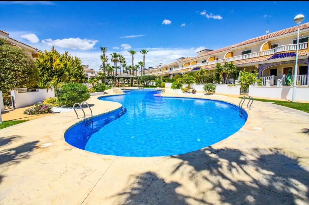 a swimming pool in the middle of a resort at Albamar in Ciudad Quesada