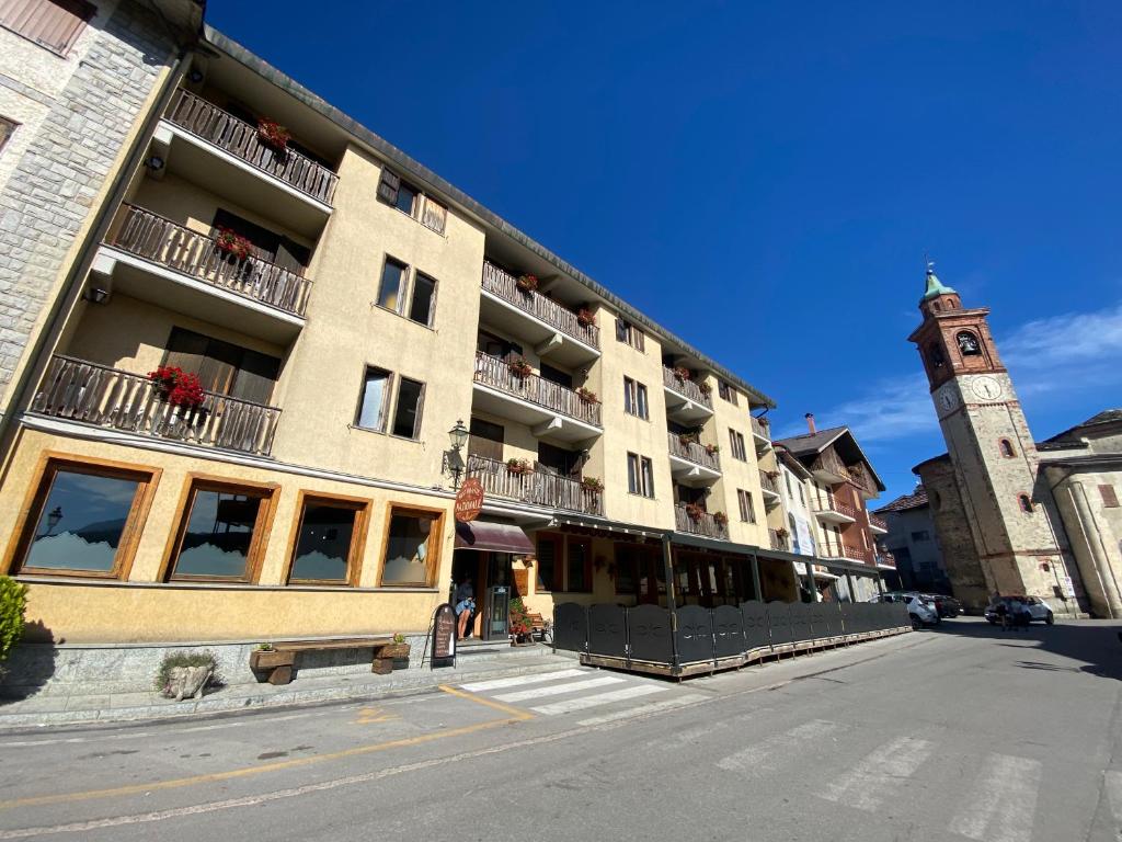 a large building with a clock tower on a street at Albergo Nazionale in San Giacomo