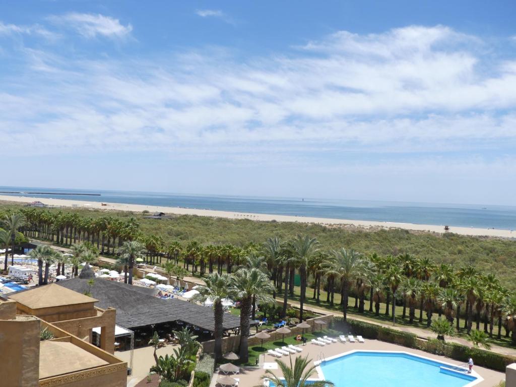 a view of the beach from the balcony of a resort at ÁTICO CUARTA PLANTA VISTAS AL MAR in Isla Canela