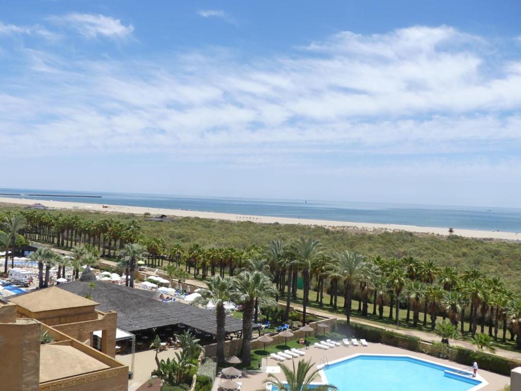 a view of the beach from the balcony of a resort at JARDINES DE ISLA CANELA By SIT ISLA CANELA -REF 171- in Isla Canela
