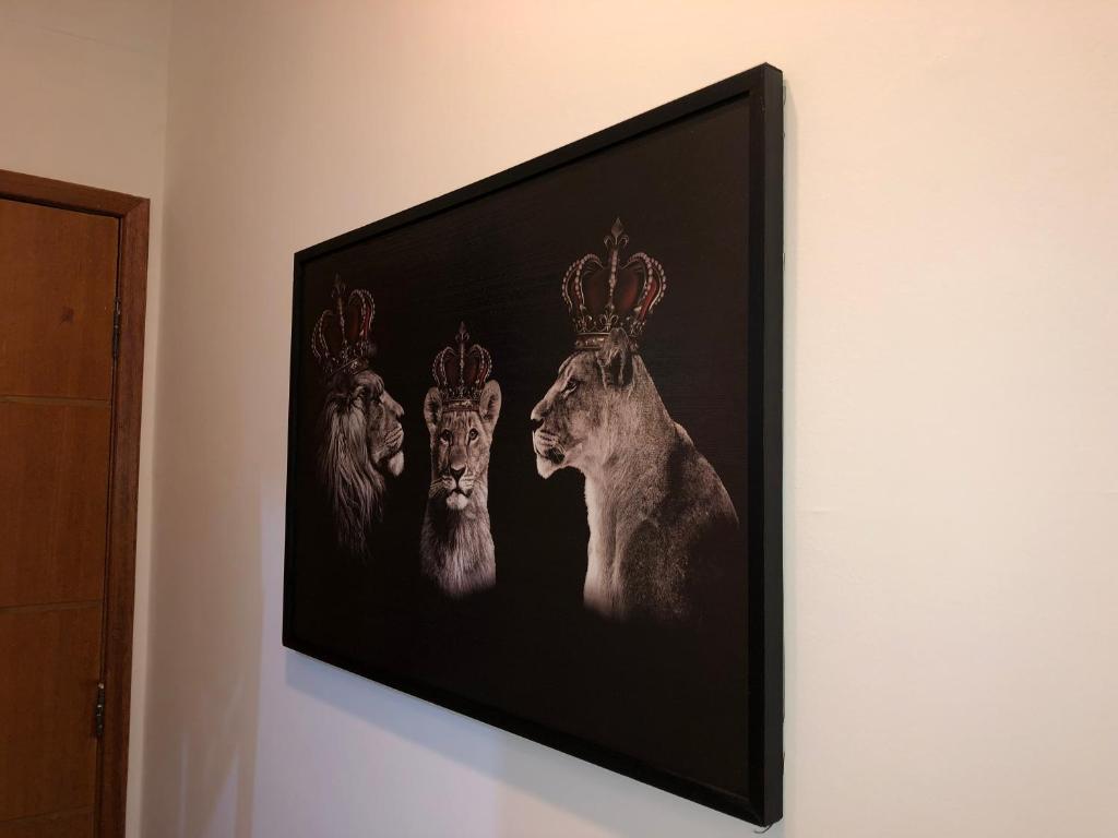 a framed picture of three deer on a wall at Lapa in Rio de Janeiro