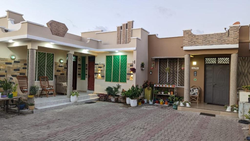 a house with a courtyard in front of it at BabaJay Family Home in Dar es Salaam