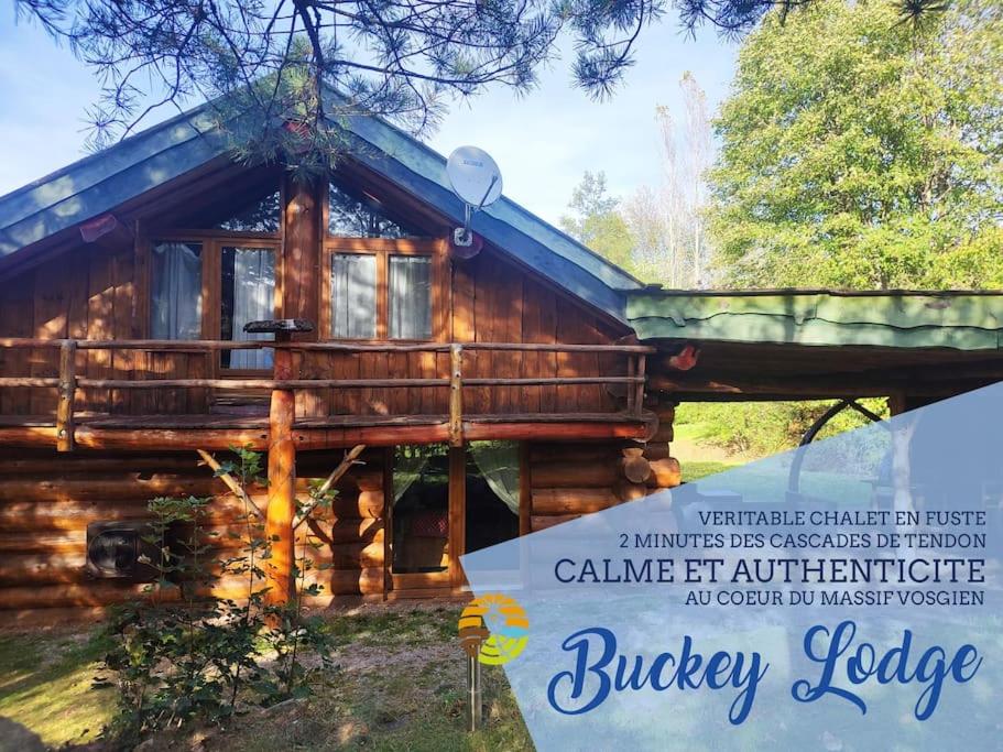 a log cabin with a sign in front of it at Buckey Lodge, à 2 minutes des cascades de Tendon in Tendon