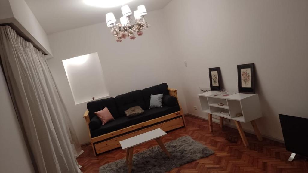 a living room with a black couch and a table at Billinghurst buenos aires in Buenos Aires