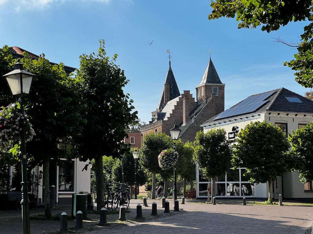 a street in a town with a church at Bed en Baguette in Burgh Haamstede