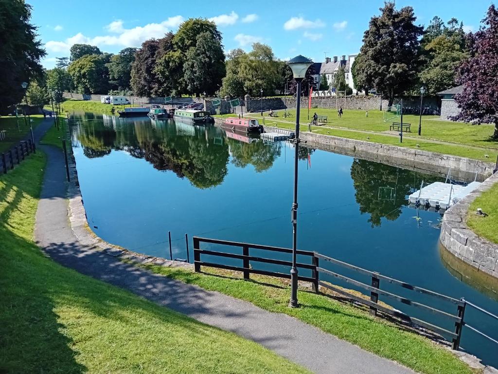 a canal in a park with boats on the water at Cuan na bPiobairí in Mullingar